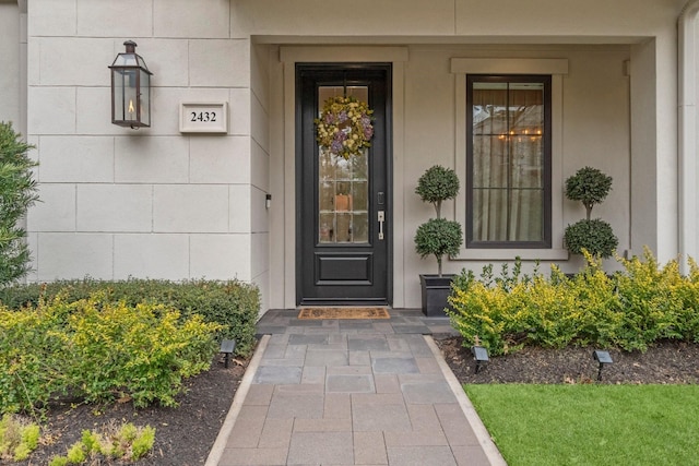 doorway to property with concrete block siding