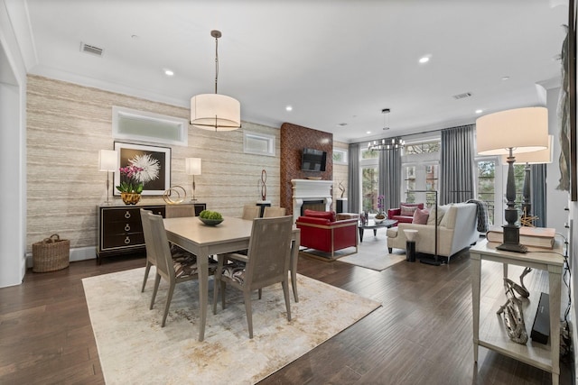 dining space with dark wood-style floors, a fireplace, visible vents, and recessed lighting