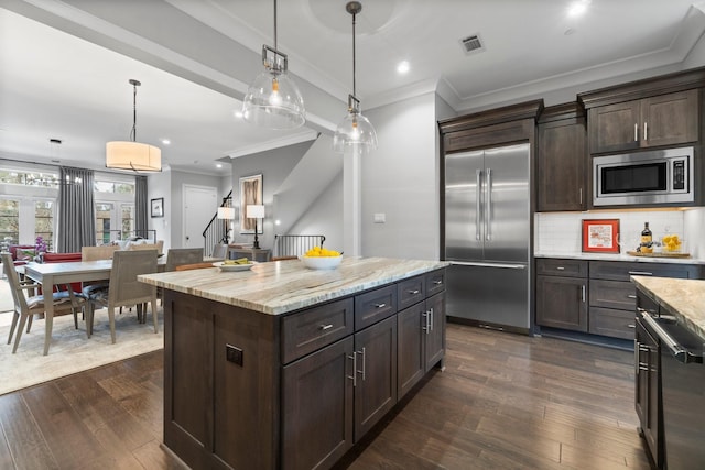 kitchen with built in appliances, dark brown cabinets, dark wood-style floors, and visible vents