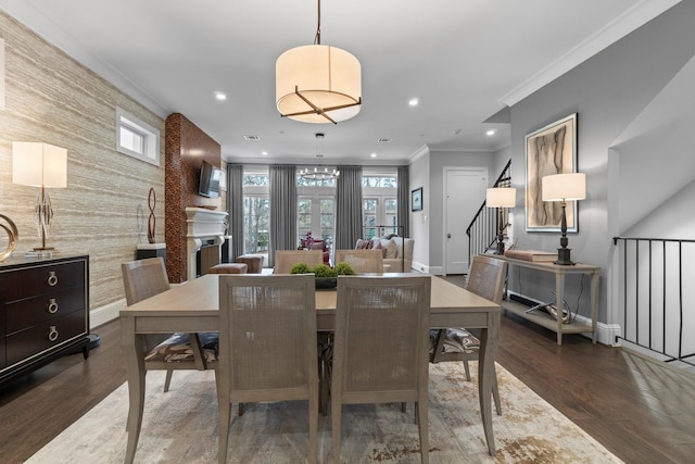 dining area featuring wallpapered walls, an accent wall, baseboards, and recessed lighting