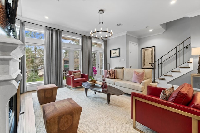 living area with stairway, ornamental molding, a fireplace, a notable chandelier, and recessed lighting