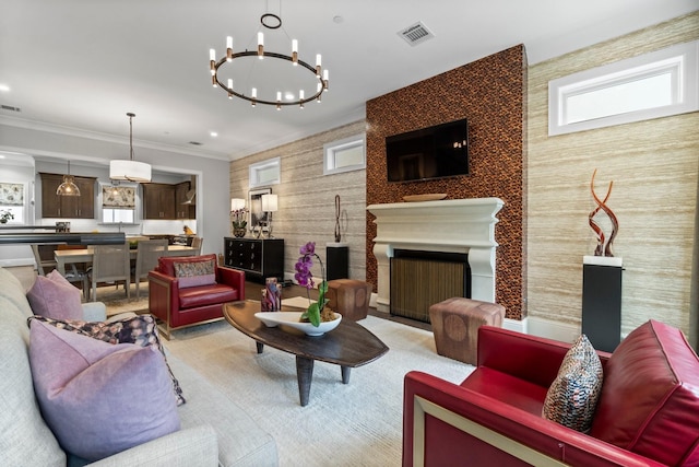 living area featuring a large fireplace, ornamental molding, visible vents, and recessed lighting