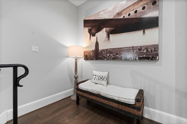 living area featuring baseboards and wood finished floors