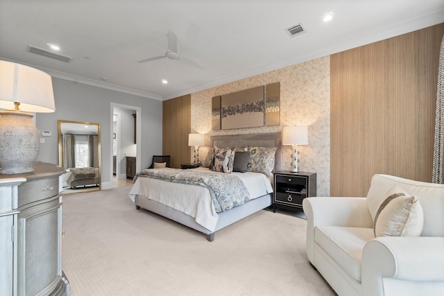 bedroom with ornamental molding, recessed lighting, visible vents, and light carpet