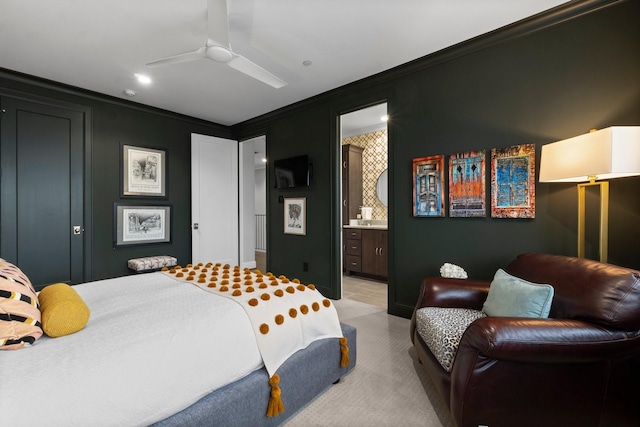 bedroom with ensuite bathroom, ceiling fan, light colored carpet, and crown molding