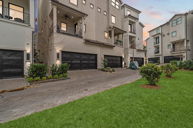 view of building exterior featuring decorative driveway and an attached garage