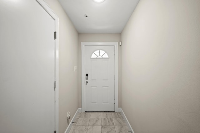 entryway featuring marble finish floor and baseboards