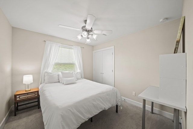 carpeted bedroom with ceiling fan, baseboards, and a closet