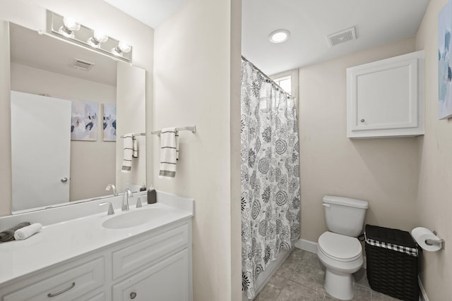 bathroom with toilet, vanity, visible vents, and tile patterned floors