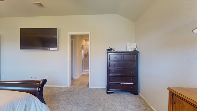 bedroom with carpet floors, baseboards, visible vents, and lofted ceiling