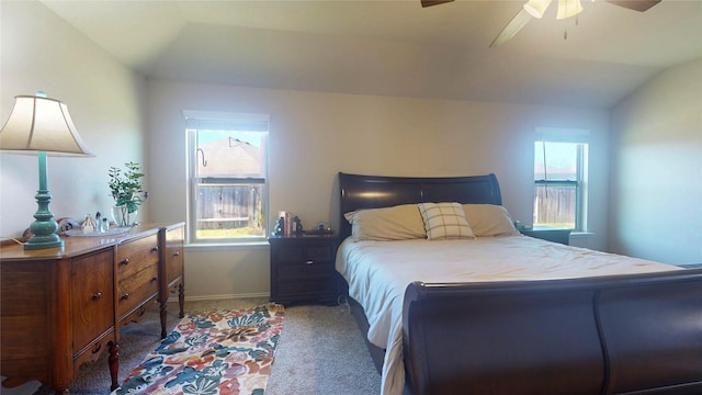 bedroom with carpet, ceiling fan, lofted ceiling, and baseboards