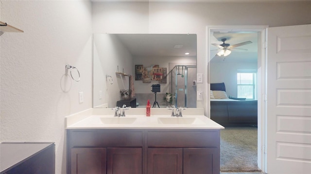 ensuite bathroom with double vanity, a stall shower, ensuite bath, and a sink