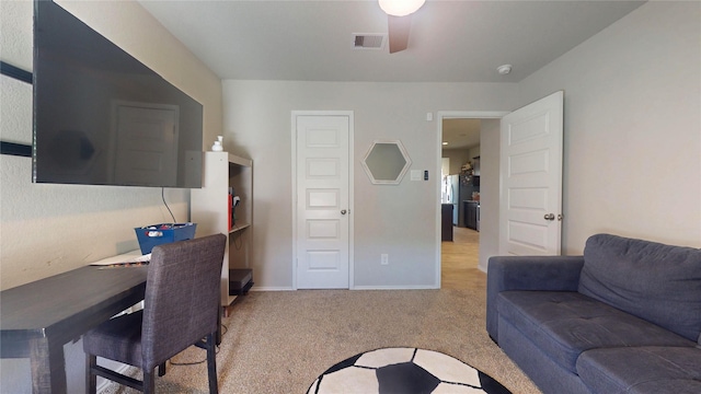 carpeted living area featuring ceiling fan, visible vents, and baseboards