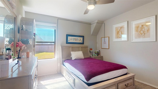 bedroom with light carpet, baseboards, and multiple windows