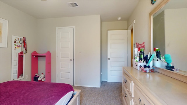 carpeted bedroom featuring visible vents