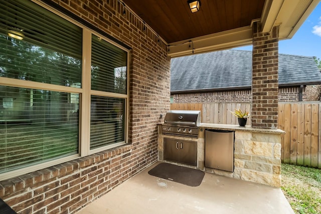 view of patio featuring fence, grilling area, and area for grilling