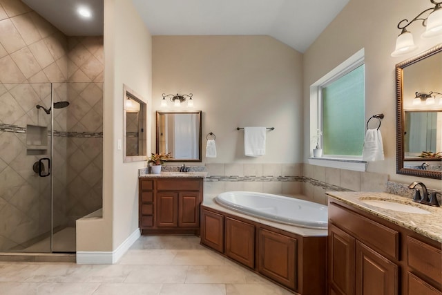 bathroom featuring a stall shower, vaulted ceiling, a sink, and a bath