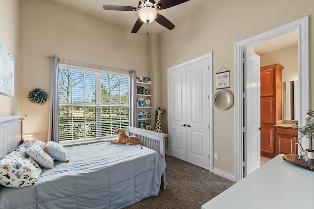 carpeted bedroom with baseboards, a ceiling fan, and a closet