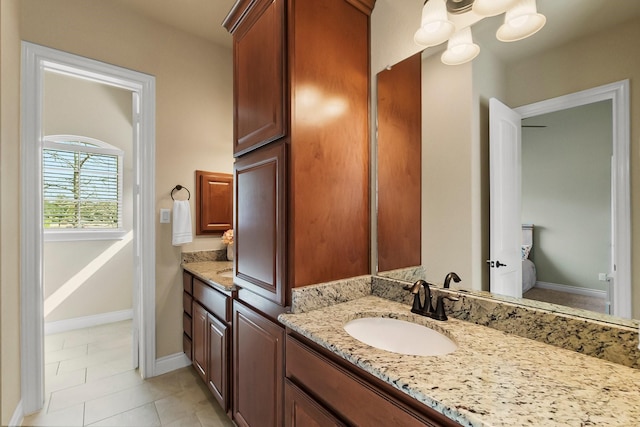 bathroom featuring tile patterned floors, baseboards, and vanity