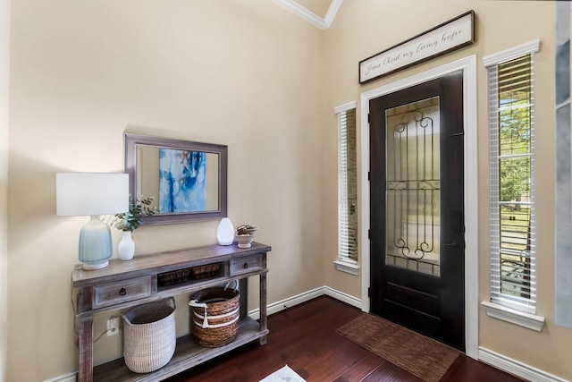 entryway featuring ornamental molding, baseboards, and wood finished floors