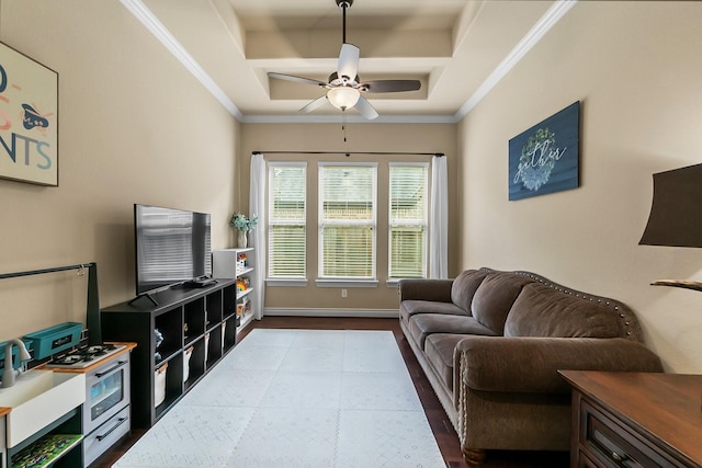 living area with dark wood finished floors, crown molding, baseboards, and ceiling fan