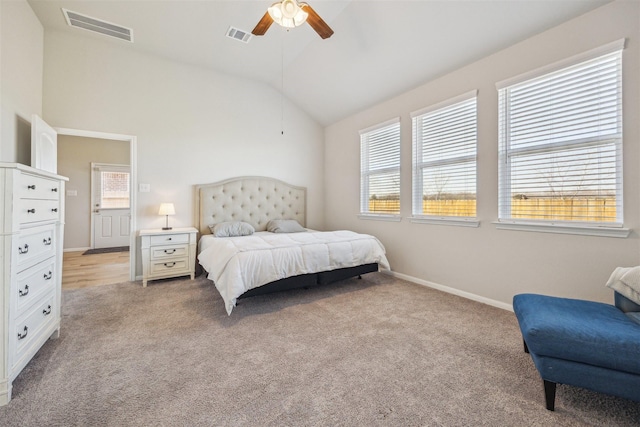 bedroom with lofted ceiling, visible vents, light carpet, and baseboards