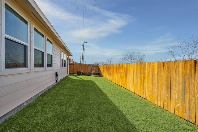 view of yard with a fenced backyard