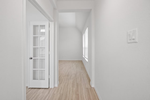 18532 Burch Creek Ln, Magnolia, TX 77355 - hallway with light wood-style floors, baseboards, and lofted ceiling
