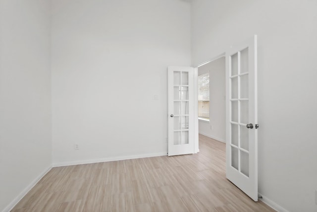 18532 Burch Creek Ln, Magnolia, TX 77355 - unfurnished room featuring french doors, light wood-type flooring, and baseboards