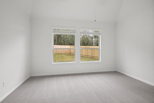 18532 Burch Creek Ln, Magnolia, TX 77355 - empty room featuring carpet flooring, vaulted ceiling, and baseboards