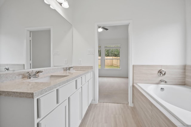18532 Burch Creek Ln, Magnolia, TX 77355 - bathroom featuring a ceiling fan, a bath, and double vanity