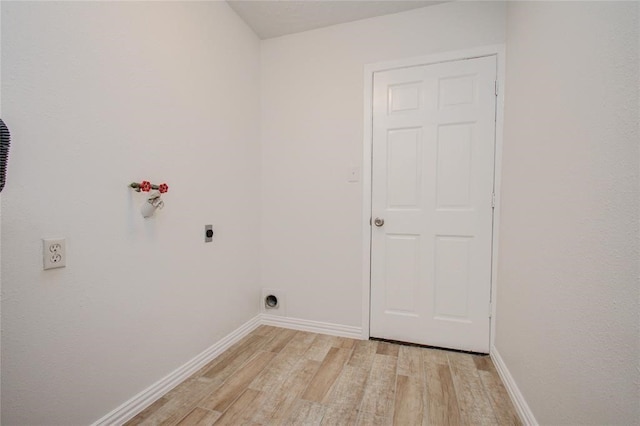 laundry area featuring laundry area, baseboards, hookup for an electric dryer, light wood-style floors, and washer hookup