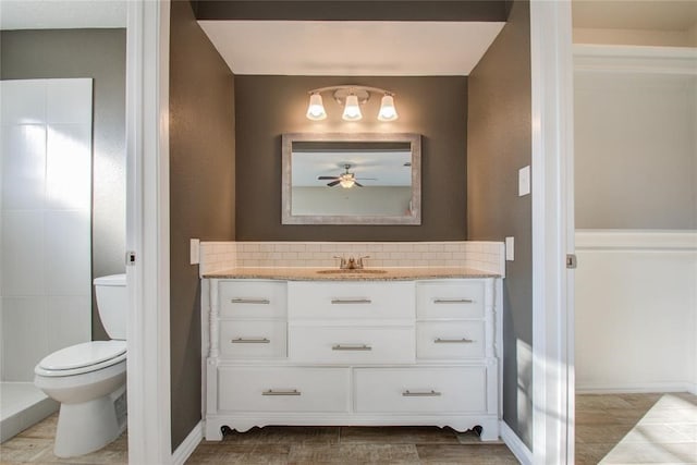 bathroom featuring backsplash, vanity, and toilet