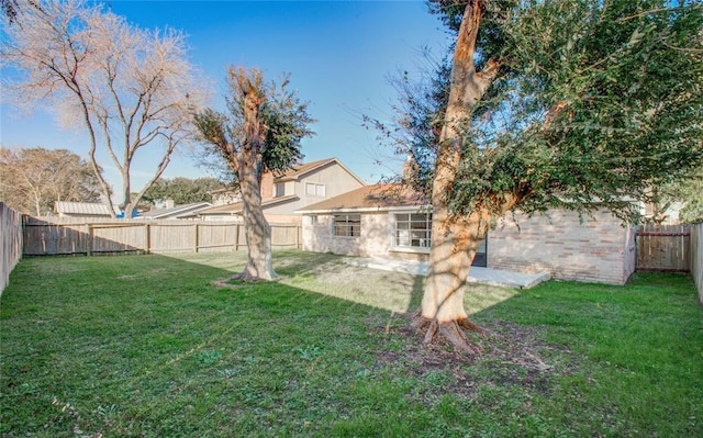 view of yard with a fenced backyard and a patio