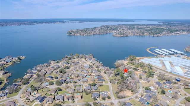 drone / aerial view featuring a residential view and a water view