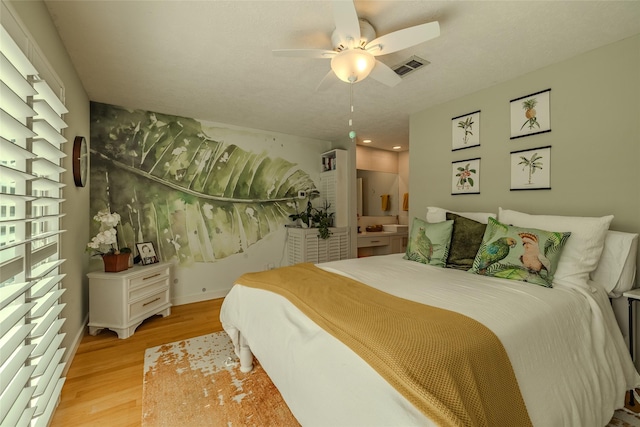 bedroom with visible vents, ceiling fan, and light wood-style flooring