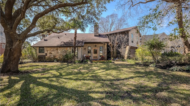 back of property featuring a yard and a chimney