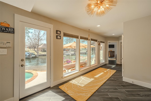 entryway with baseboards, dark wood finished floors, a notable chandelier, and recessed lighting