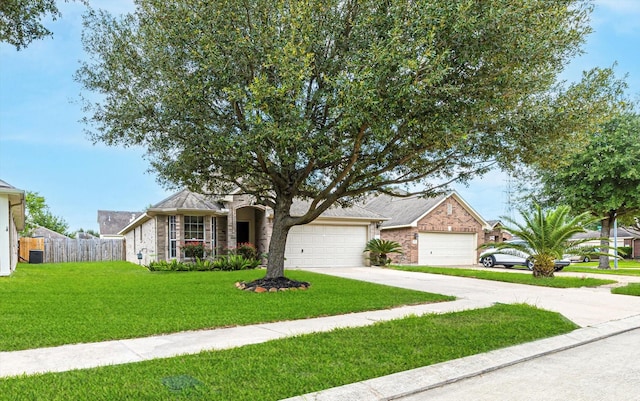 single story home featuring driveway, a garage, fence, a front yard, and brick siding