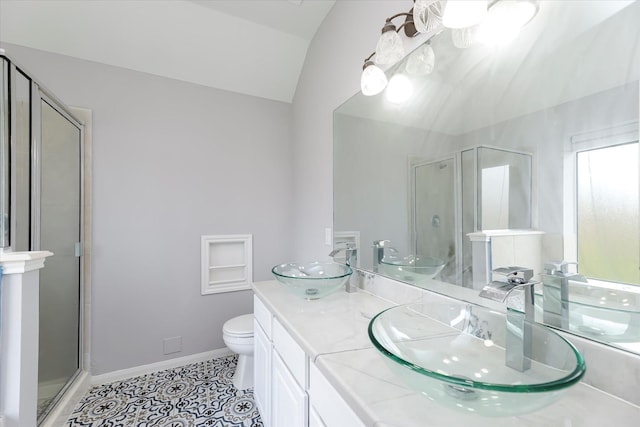 bathroom featuring tile patterned flooring, a sink, and a shower stall