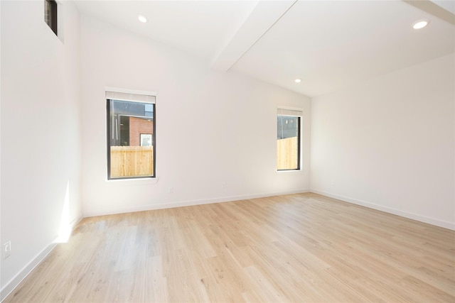 unfurnished room with lofted ceiling, baseboards, wood finished floors, and recessed lighting