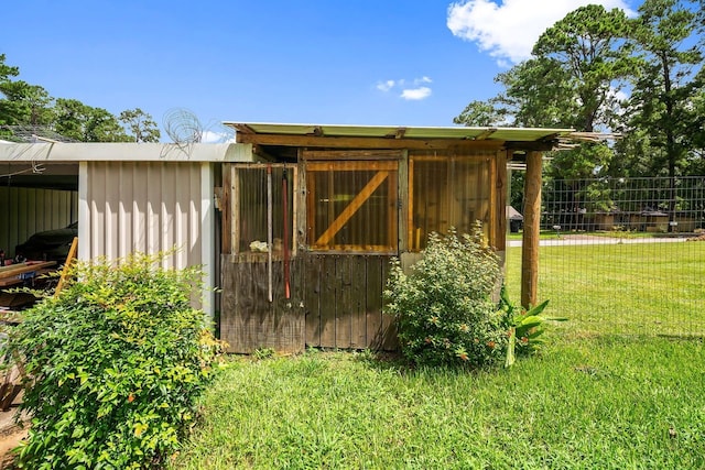 view of outbuilding with an outbuilding and fence