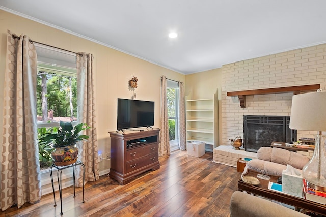 living room with hardwood / wood-style flooring, a fireplace, and ornamental molding