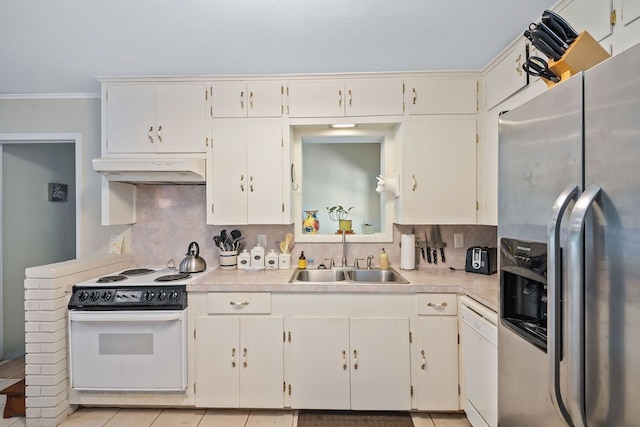 kitchen featuring light countertops, backsplash, a sink, white appliances, and under cabinet range hood