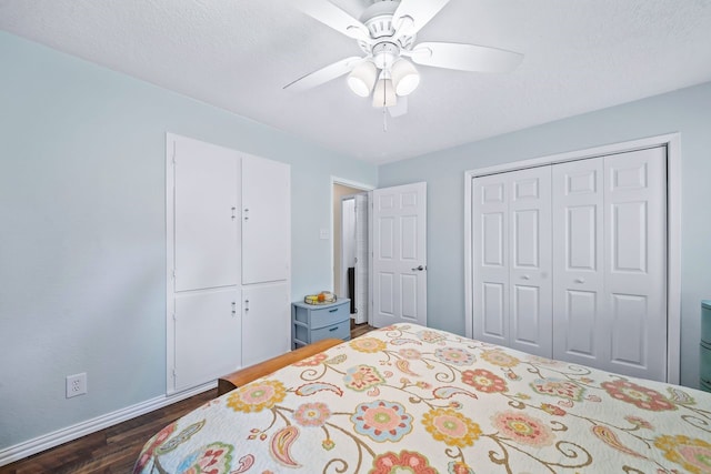 bedroom with a closet, a textured ceiling, a ceiling fan, and dark wood-type flooring