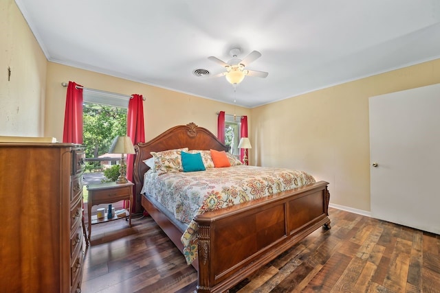 bedroom with ceiling fan, dark wood-type flooring, visible vents, and baseboards