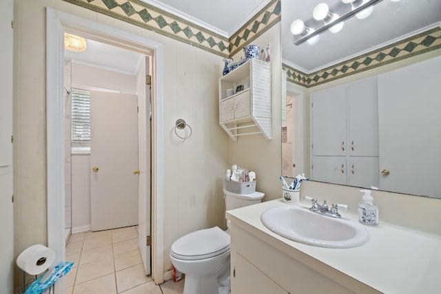 bathroom featuring toilet, ornamental molding, vanity, and tile patterned floors