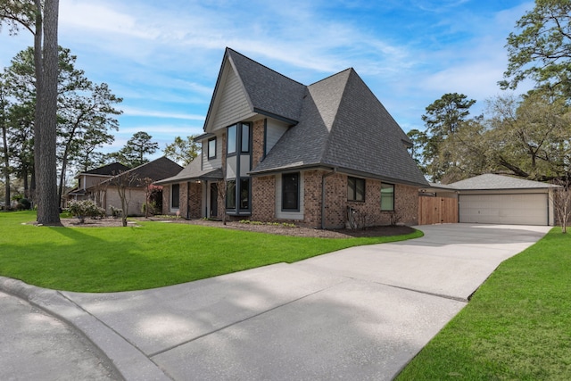 view of property exterior with a lawn, roof with shingles, an outdoor structure, a garage, and brick siding