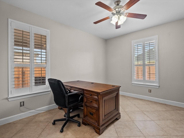 office space featuring light tile patterned flooring, baseboards, and ceiling fan