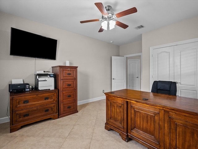 home office with light tile patterned floors, visible vents, baseboards, and a ceiling fan